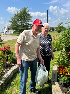 GardenIMG_2435 residents walking through raised flower bed garden