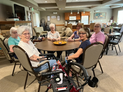 6 women sitting around a table